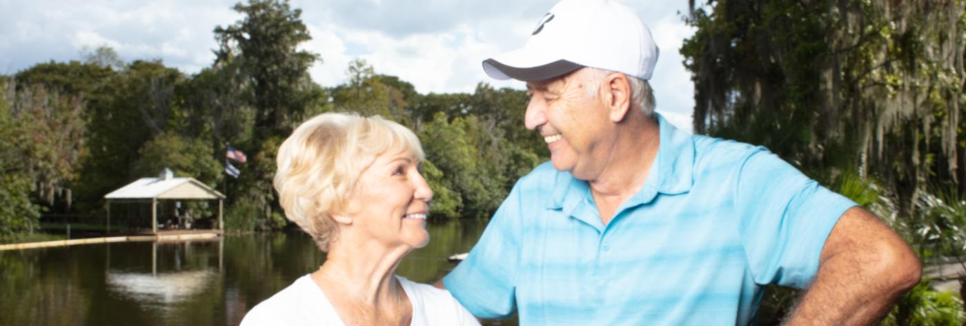 couple standing next to a lake in Sumter County, FL