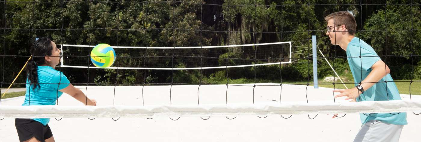 two people playing volleyball in Sumter County, FL